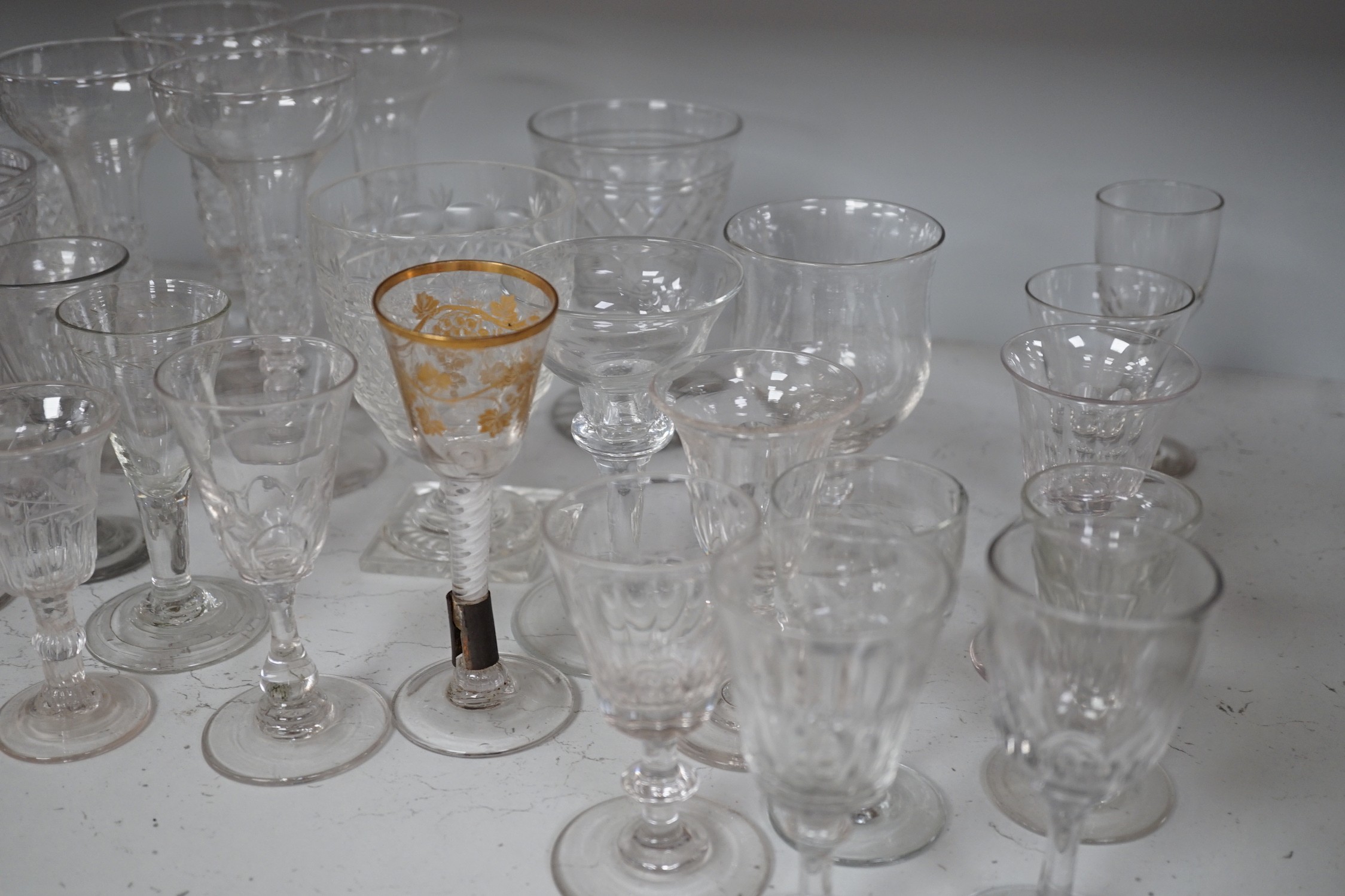 A quantity of assorted 18th / 19th century and later clear drinking glasses including a damaged James Giles gilt decorated opaque twist stem wine glass.